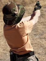 Boy with a gun outside