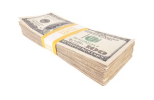 Wad of several hundred dollar bills against a white background