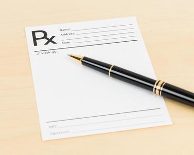 An RX slip with a pen. Forging a prescription qualifies as second-degree forgery in Colorado. 