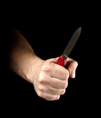 man displaying a switchblade in his first; this weapon in still illegal in some Colorado cities, such as Denver and Boulder