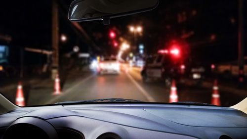 car approaching a DUI sobriety checkpoint at night