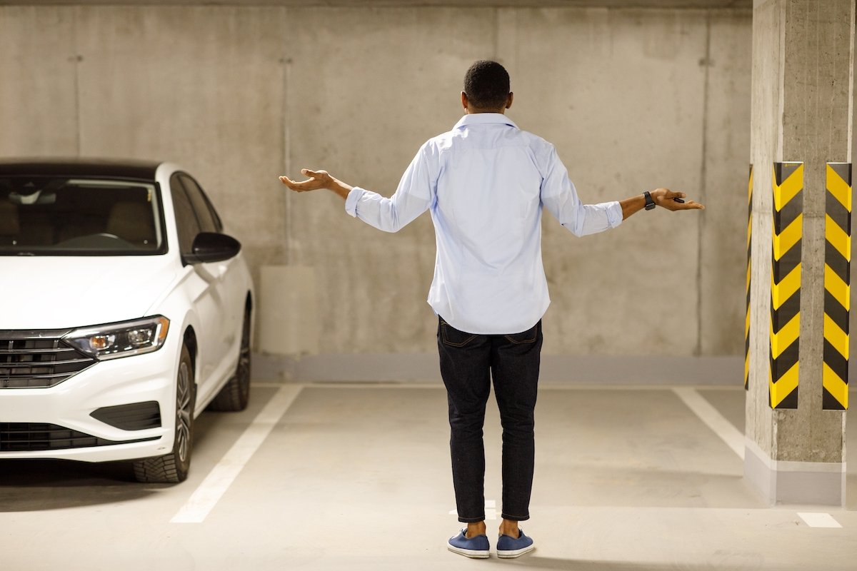 Man in empty parking lot spot after realizing his car has been stolen