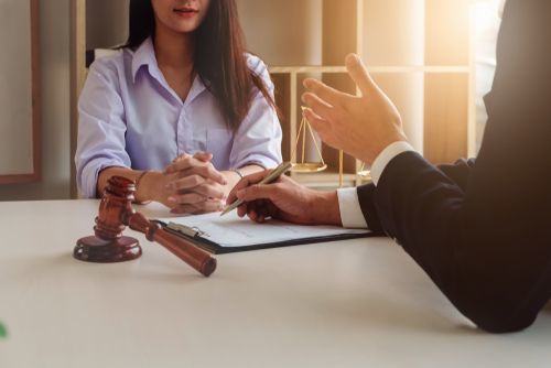 A defendant meeting with an attorney, who appears engaged and to be providing competent legal representation.