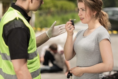 Police administering breath test to DUI suspect
