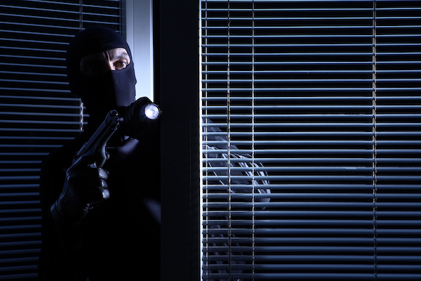 A burglar entering someone else's property with a gun as an example of first-degree burglary per Colorado CRS 18-4-202