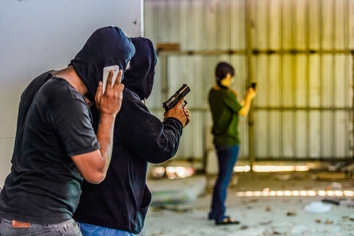 Two men standing guard as an example of accomplices to a crime in Colorado
