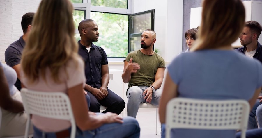 Group of intensive supervision participants sitting in a circle during a counseling session