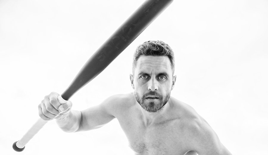 Man holding baseball bat about to strike