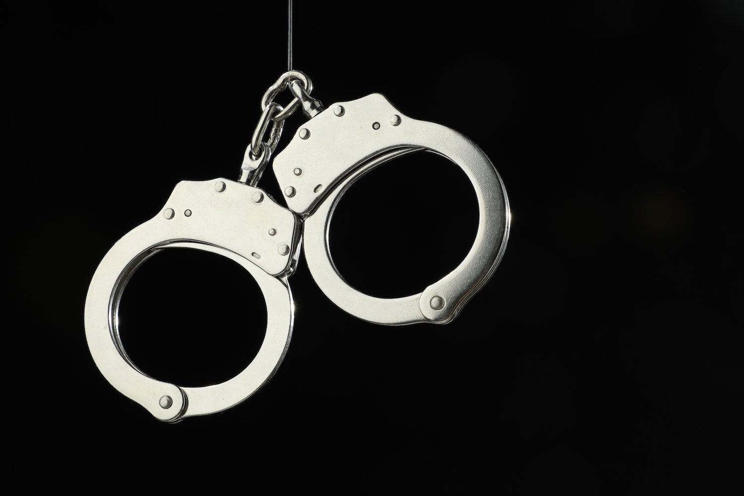 Handcuffs against a black background