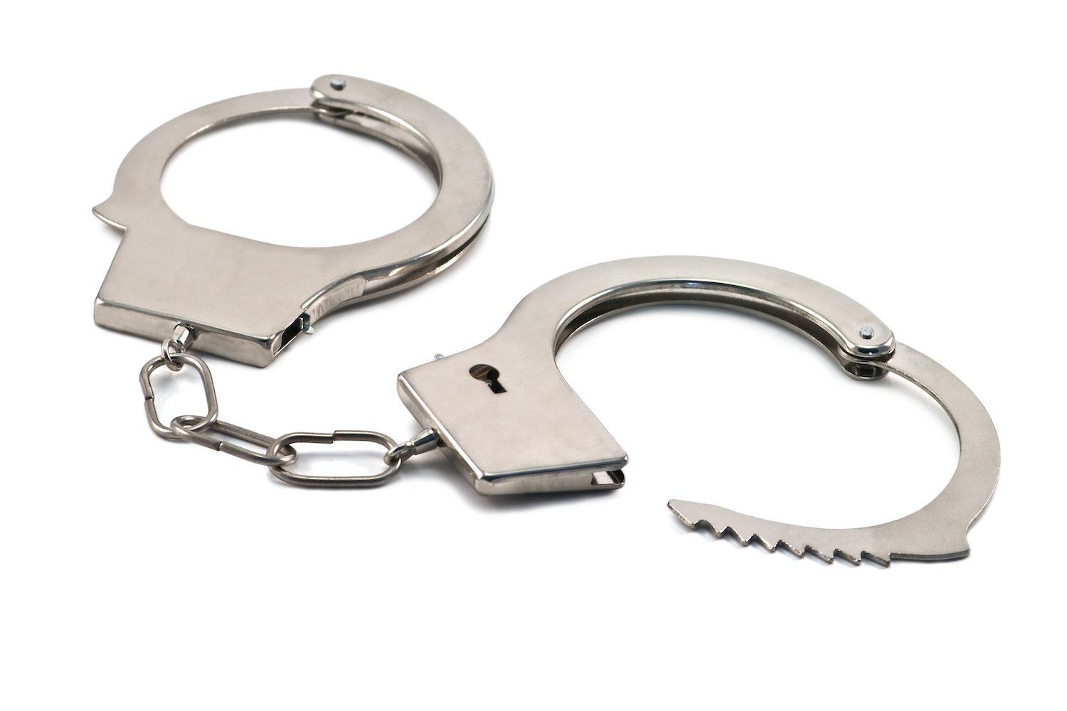 Open handcuffs against a white background