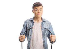 Teen holding broken electric cord he broke in violation of CRS 18-4-506