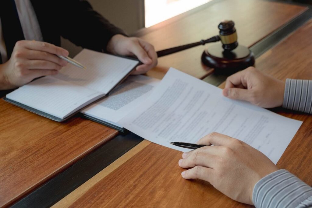 Judge giving diversion defendant a contract to sign, and the judge is reading from a notebook and is holding a gavel