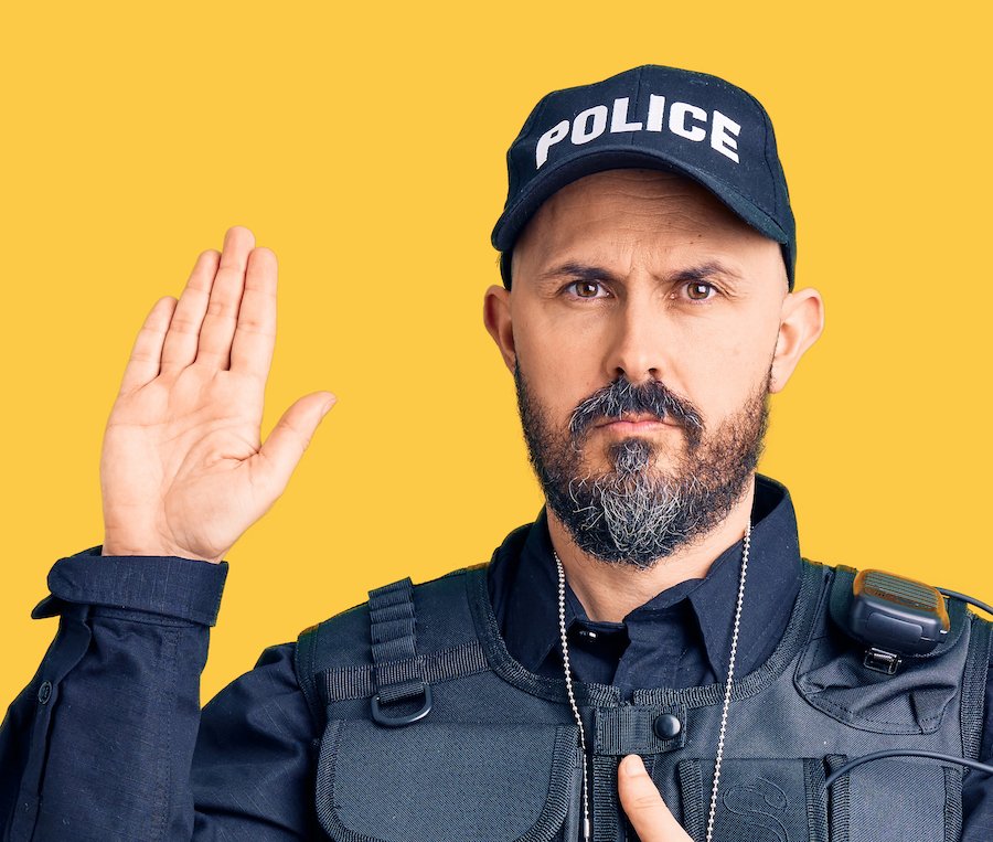 Policeman taking an oath during a DMV hearing against an orange background