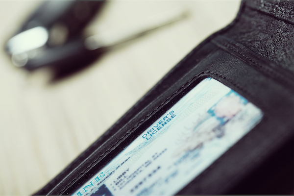 A driver's license in a wallet that can be suspended if the license-holder accrues too many DMV points. 