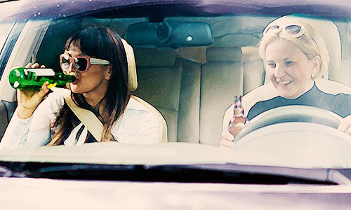 two women seated in car drinking beers as an example of a violation of Colorado open container laws in CRS 42-4-1305