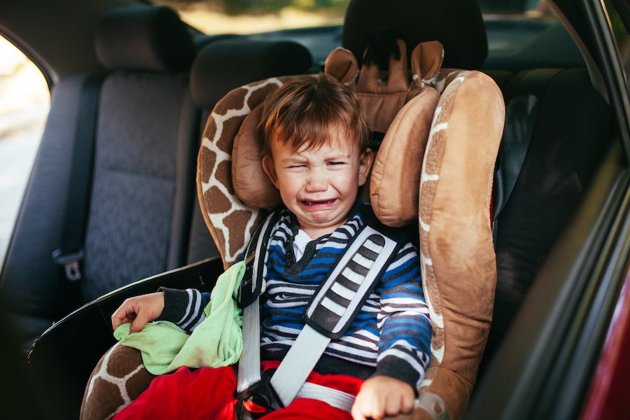 crying child in car seat while his parent is driving under the influence