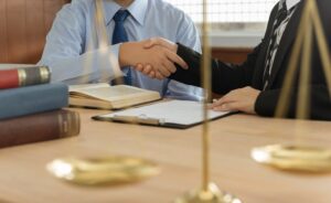 attorneys shake hands with client