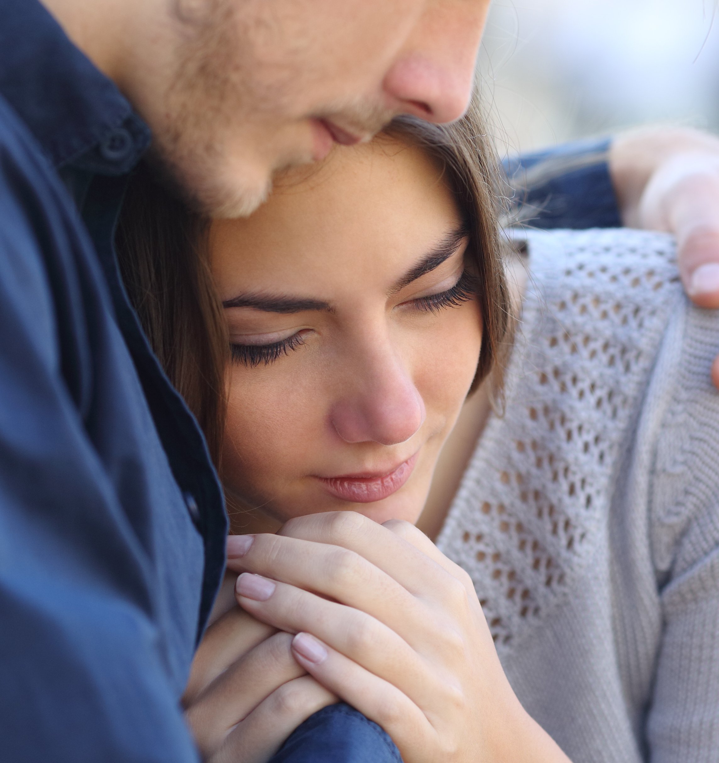 Older man and younger woman in an embrace