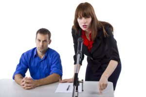 Defense attorney advocating for client during an evidentiary hearing against a white background