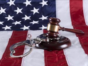 Flag, gavel, and handcuffs