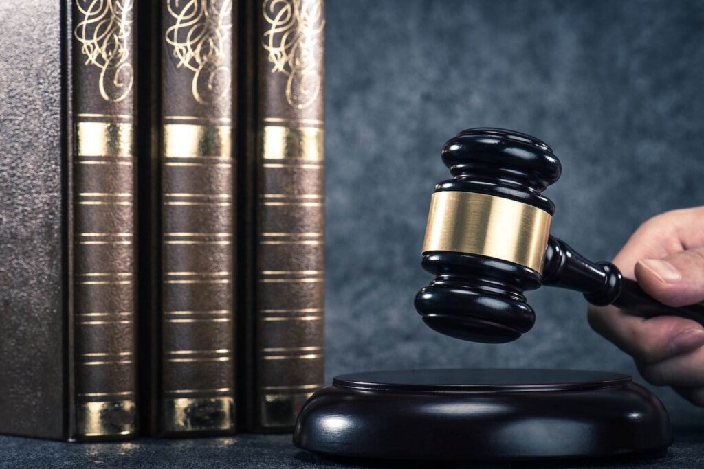 gavel next to three law books