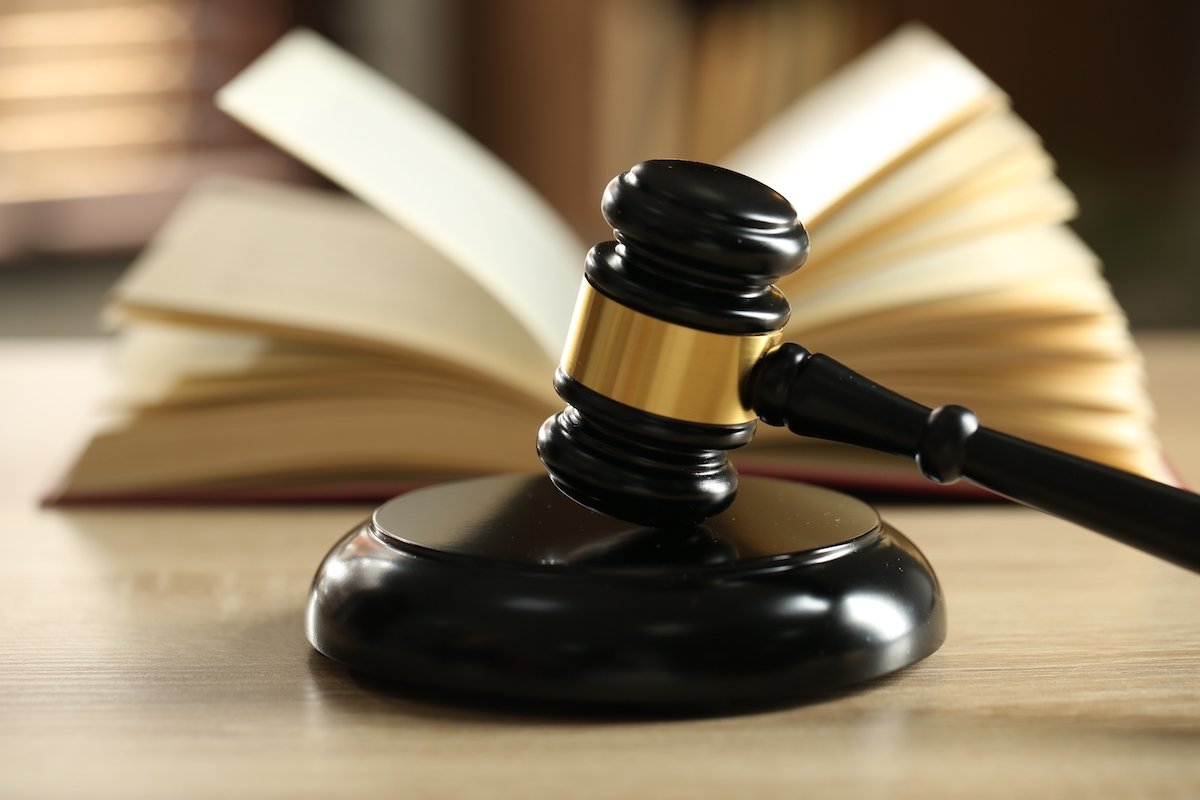 Judge's gavel in front of a law book in judge's chambers