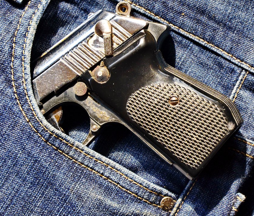 Revolver in the pocket of a pair of jeans