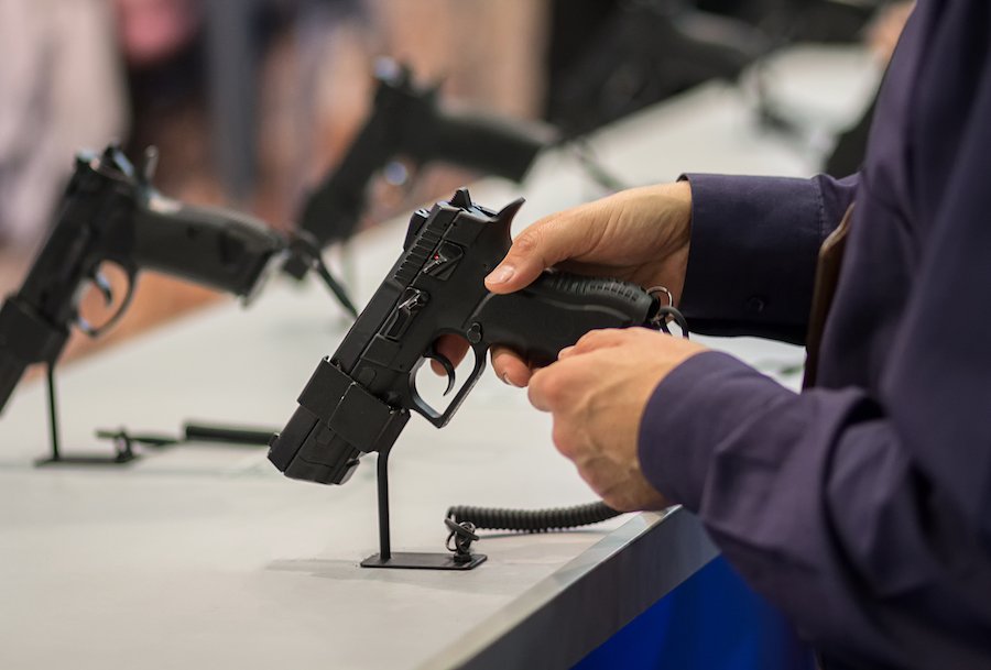 Man in a Colorado gun store contemplating buying a gun