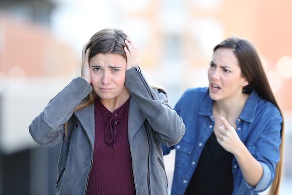 Woman taunting another woman on the street as an example of a violation of the harassment statute in Colorado