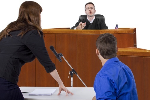 Attorney with client before judge