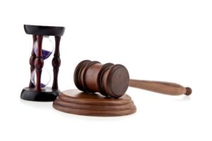 Gavel and hourglass against white background to represent speedy trial rights