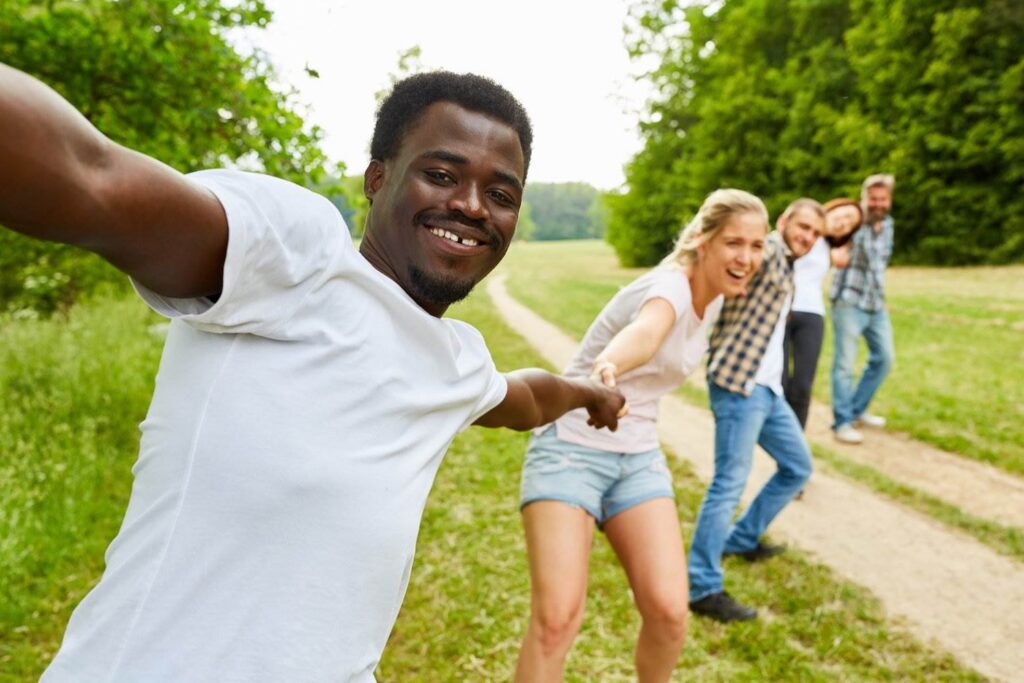 Teenagers make a human chain over a path to illustrate a violation of CRS 18-9-107