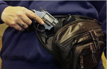 Woman with current and valid permit carrying a gun concealed in a fanny-pack. 