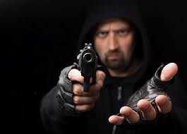 robber pointing a gun with other hand extended as an example of aggravated robbery in Colorado