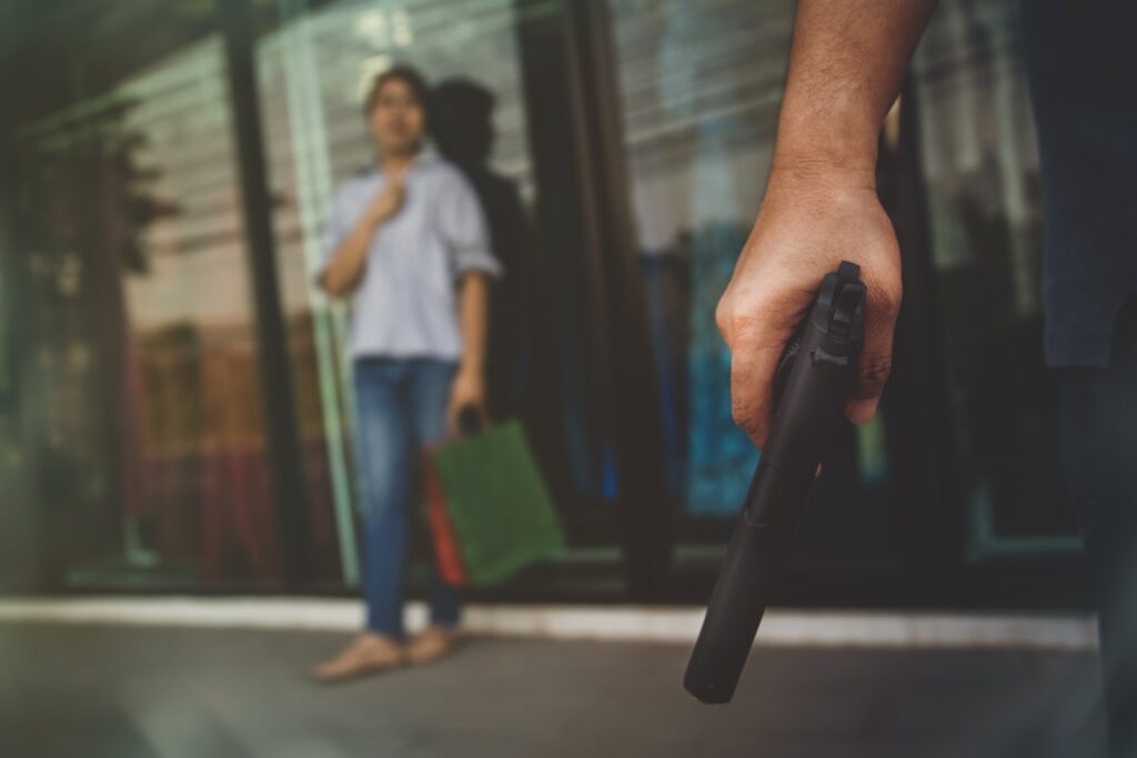 Witness accosted on the street by a person with a gun trying to intimidate him into not testifying. 