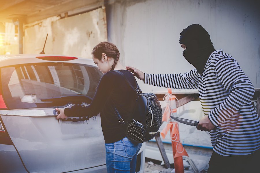 Girl being robbed by masked man with knife