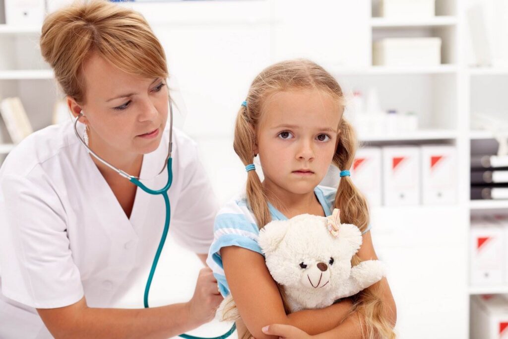 Female doctor - who is a mandatory reporter under Colorado law - examining a child patient. 