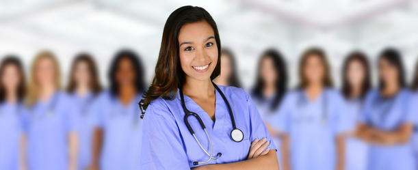 A group of 10 smiling female nurses wearing scrubs and stethoscopes around their necks