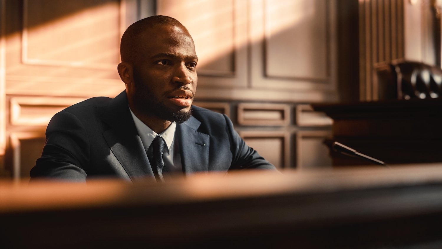 Man on the witness stand during a trial about to commit perjury