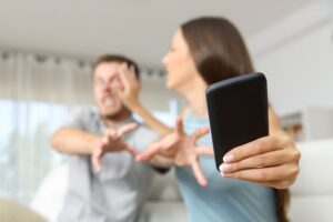 Woman violating CRS 18-9-306.5 by grabbing phone away from man reaching for it