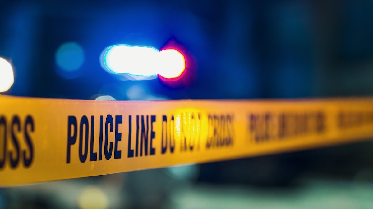 Yellow "police line do not cross" tape cordoning off a crime scene