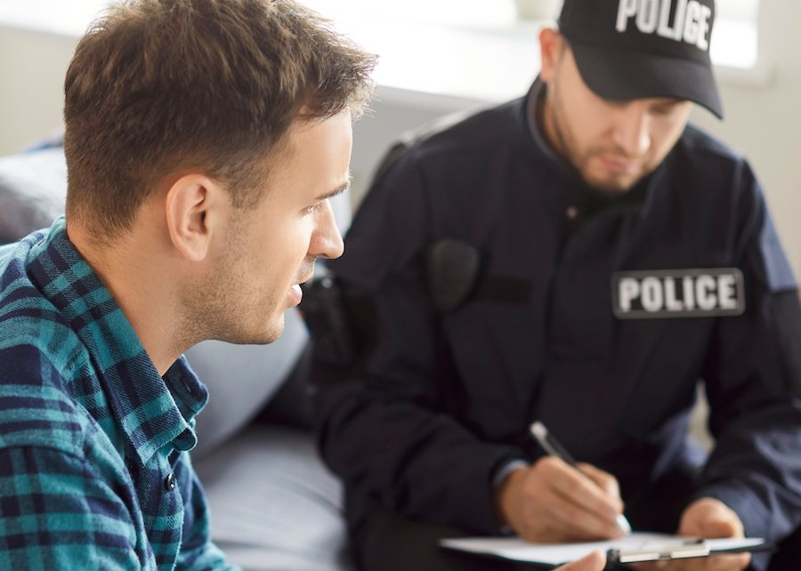 Man checking in with a police officer