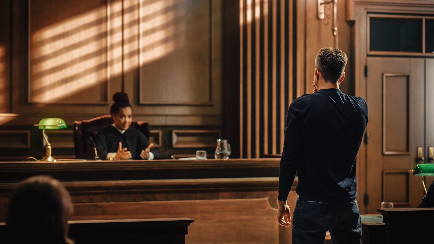 Man being arraigned for promotion of obscenity in a courtroom