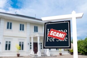 Home for Sale sign with a red "SCAM!" sticker over it