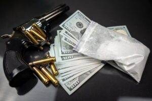Bag of cocaine with cash, gun and bullets - instruments of a CRS 18-17-104 violation