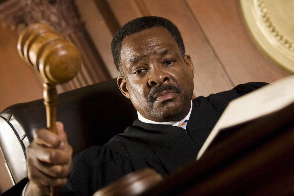 Judge hammering gavel at bench - judge's in Colorado may offer the defendant a deferred judgment and sentence