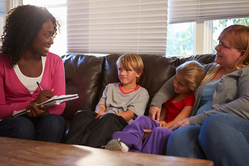 Social worker speaking with family on couch