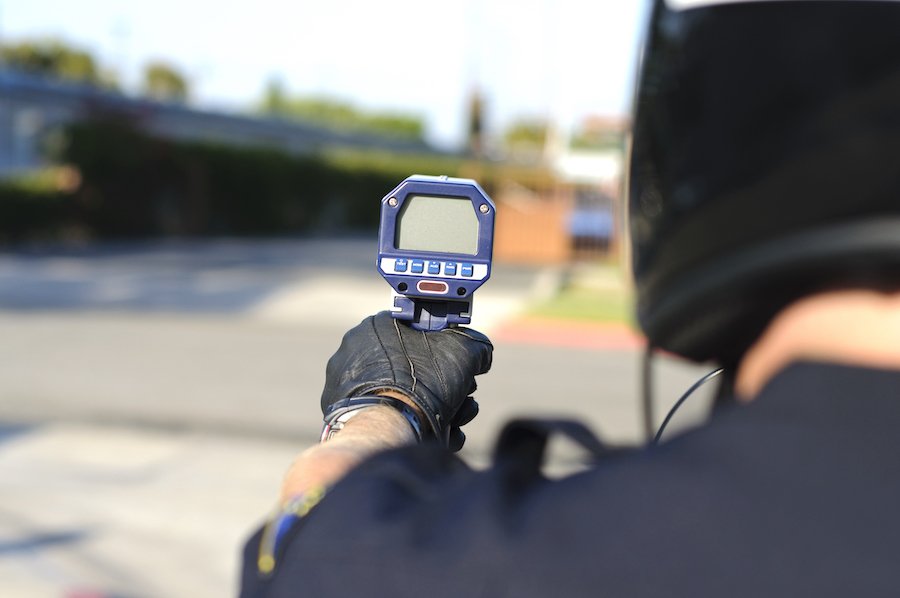 Officer with radar speed gun