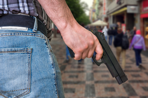 Man about to shoot across a public road in violation of CRS 33-6-126.