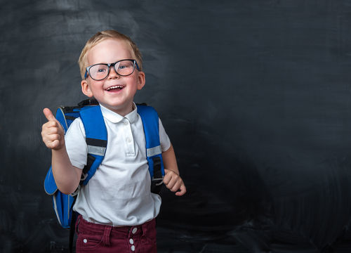 smiling child with backpack going to school